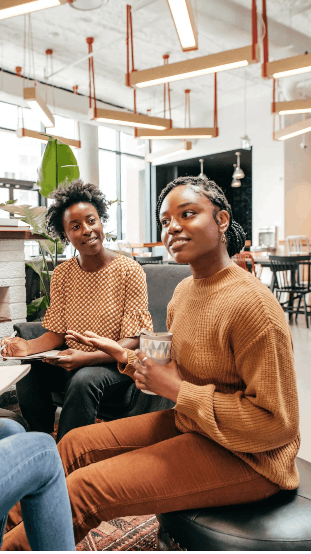 Two women sharing a conversation in a workspace